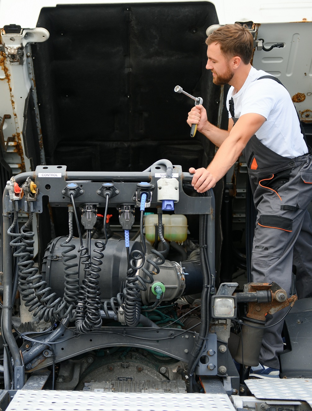 Professional truck mechanic working in vehicle repair service.